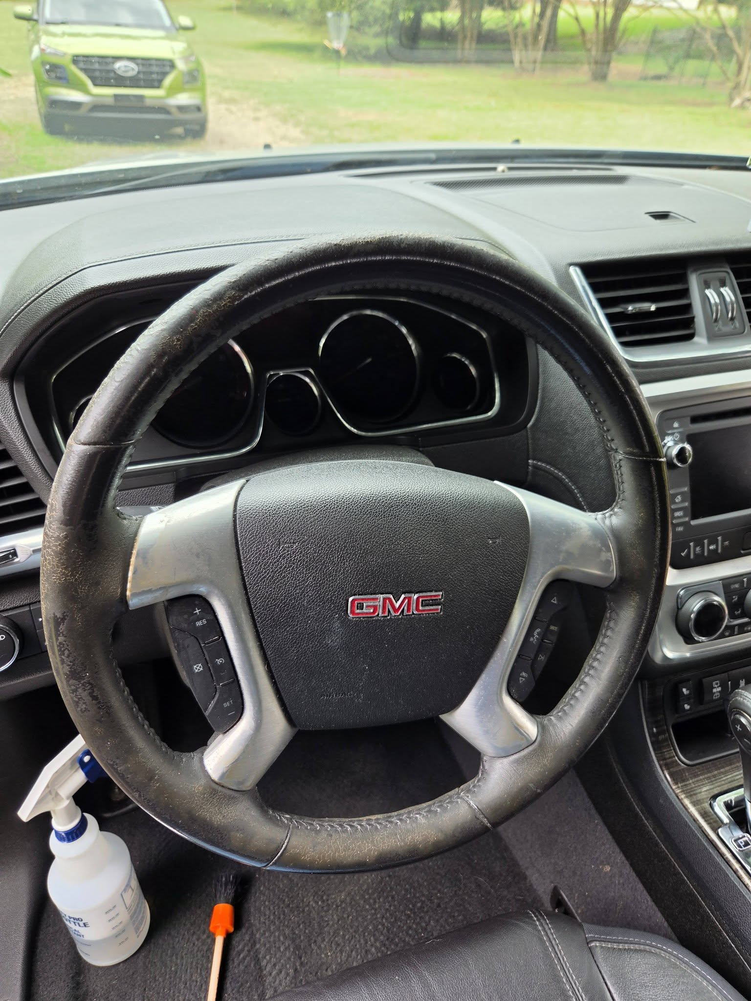 GMC steering wheel before detailing — grime visible